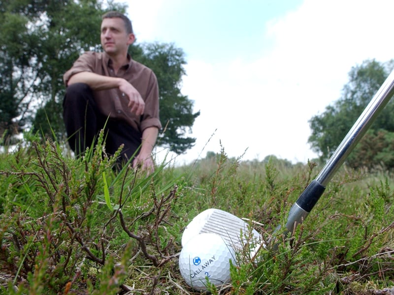 July 2003 and Moortown Golf Club had entered into a partnership with Defra to restore traditional heathland which was once characterised the course. Pictured a golfer finds himself in the rough between the heather as Andy Mackintosh, Defra project manager, looks on.