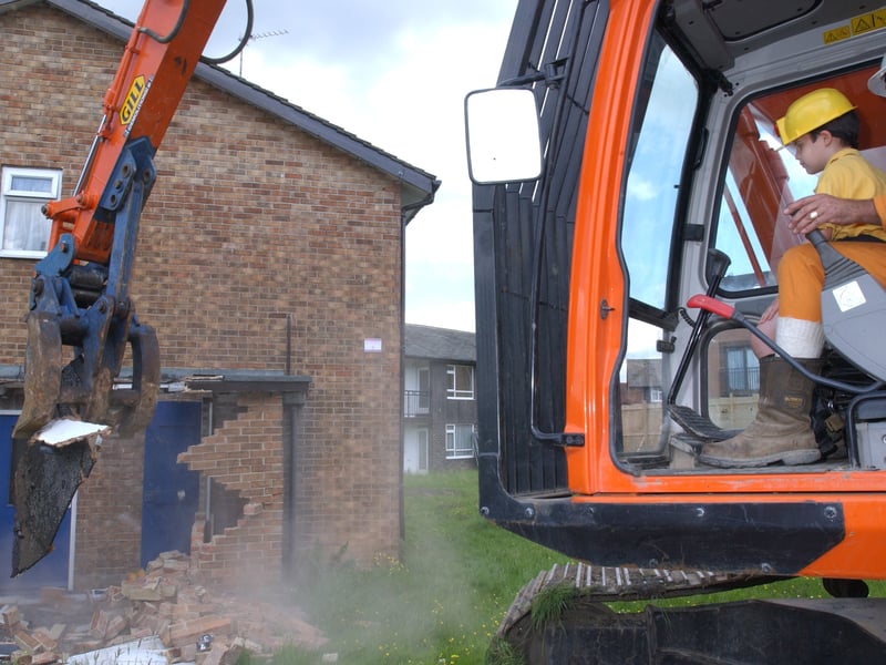 Arnold Ziff s grandson Jacob takes the controls to demolish old properties at the site of a new housing project on Queenshill Avenue in June 2003.
