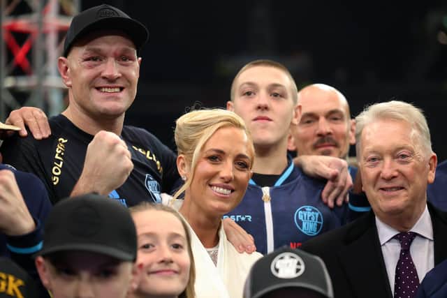 Tyson Fury poses for a photo with his wife, Paris Fury, and Frank Warren, after beating Arslanbek Makhmudov in his most recent fight.