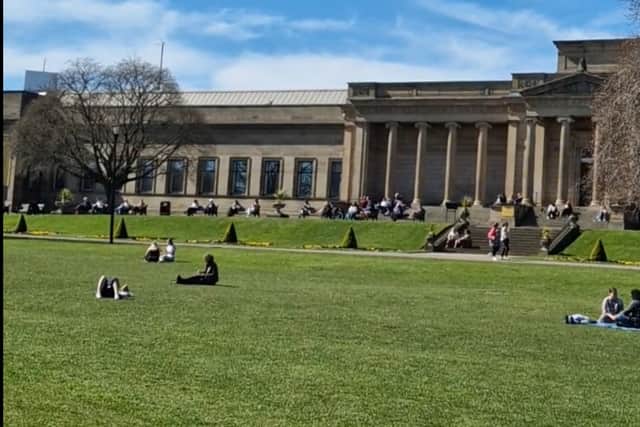People enjoying the hot weather outside Weston Park Museum, Sheffield/ Photo: David Kessen, Iconic Media