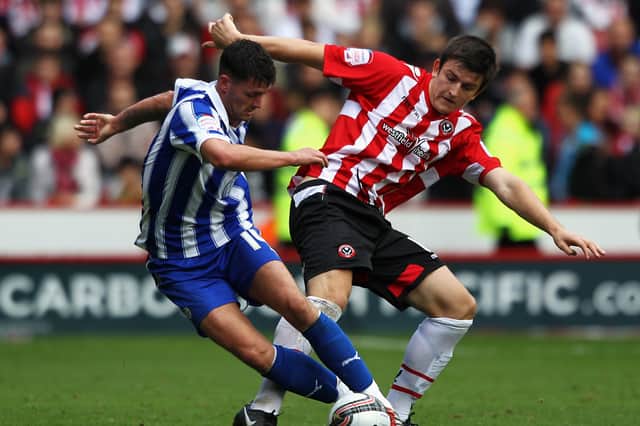 SHEFFIELD, ENGLAND - OCTOBER 16: Harry Maguire of Sheffield United and Gary Madine of Sheffield Wednesday battle for the ball during the npower League One match between Sheffield United and Sheffield Wednesday at Bramall Lane on October 16, 2011 in Sheffield, England. (Photo by Dean Mouhtaropoulos/Getty Images)