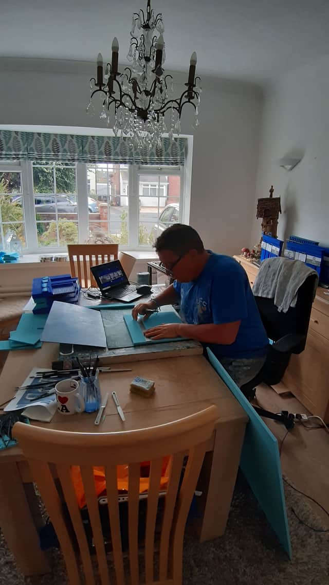 Damien Kennedy in action putting together a model of Hillsborough Kop