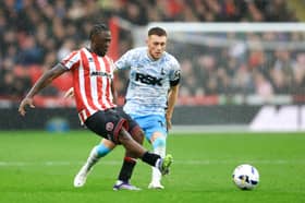 Alex Matos of Sheffield United passes the ball whilst under pressure from Sonny Carey of Charlton Athletic during the Sky Bet Championship match between Sheffield United and Charlton Athletic at Bramall Lane on September 20, 2025 in Sheffield, England. 