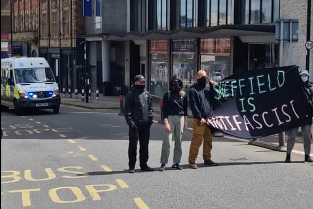 Anti-rascism campaigners unfurl a banner on the route of the right wing march through Sheffield. Photo: Iconic Media