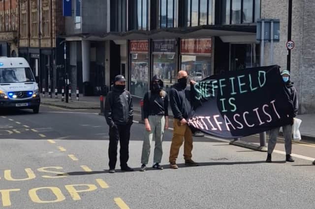 Anti-rascism campaigners unfurl a banner on the route of the right wing march through Sheffield. Photo: Iconic Media