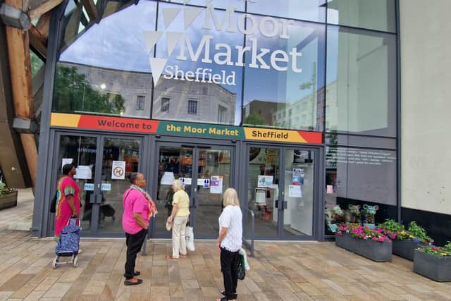 People gather outside The Moor Market which is closed due to cockroaches.