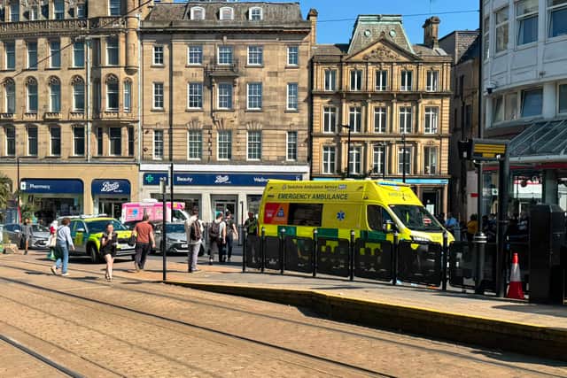 An ambulance at the Sheffield Cathedral tram stop after a pedestrian was injured in a collision with a car on Wednesday afternoon. Photo: Iconic Media