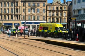 An ambulance at the Sheffield Cathedral tram stop after a pedestrian was injured in a collision with a car on Wednesday afternoon. Photo: Iconic Media