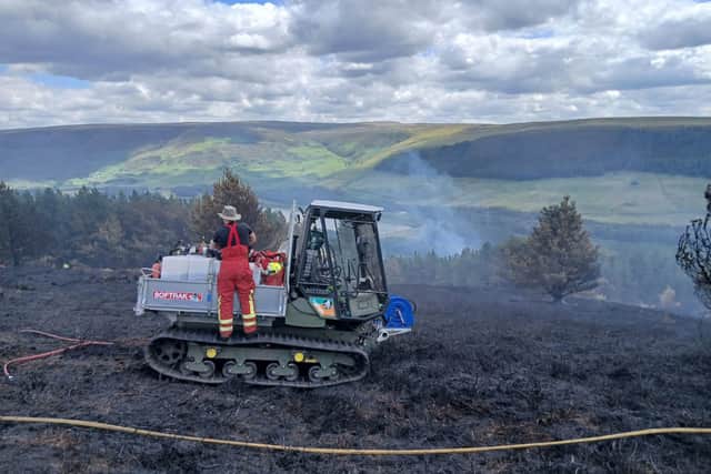 Firefighters battle the blaze on Tintwistle Moor. Photo: Peak District National Park Authority