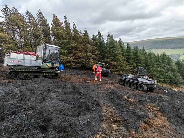 Firefighters battle the blaze on Tintwistle Moor. Photo: Peak District National Park Authority
