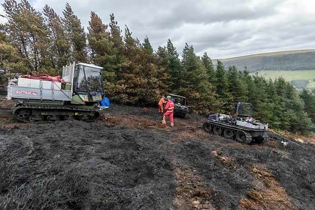 Firefighters battle the blaze on Tintwistle Moor. Photo: Peak District National Park Authority