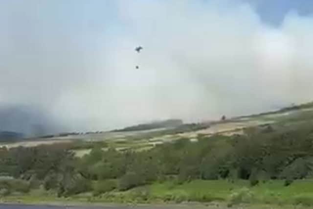 Smoke spreading over the hills near Woodhead Reservoir in the Peak District.. Photo: SWNS
