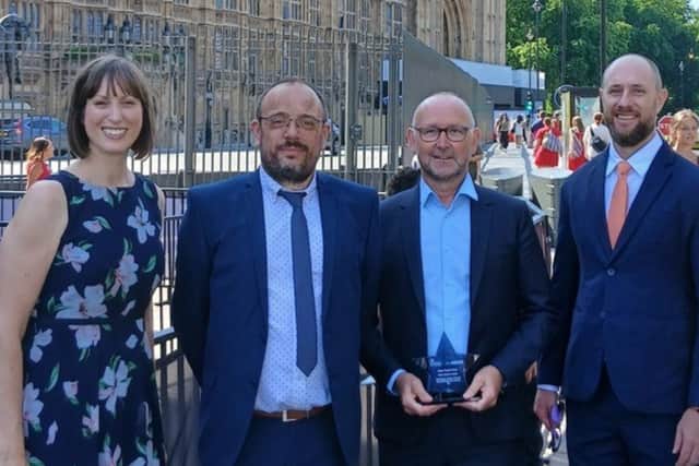 Derbyshire highways representatives Richard Handbury, traffic and safety commissioner, second left, and Julian Gould, second right, highways director, with the Safer Roads Fund award at the House of Lords.
