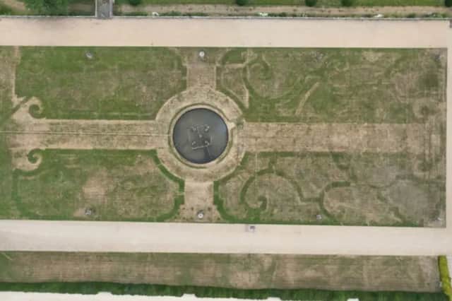 The outline of an ornate 17th-century garden 'The Great Parterre' at Chatsworth House in Derbyshire - revealed by the recent record-high temperatures and long dry periods.