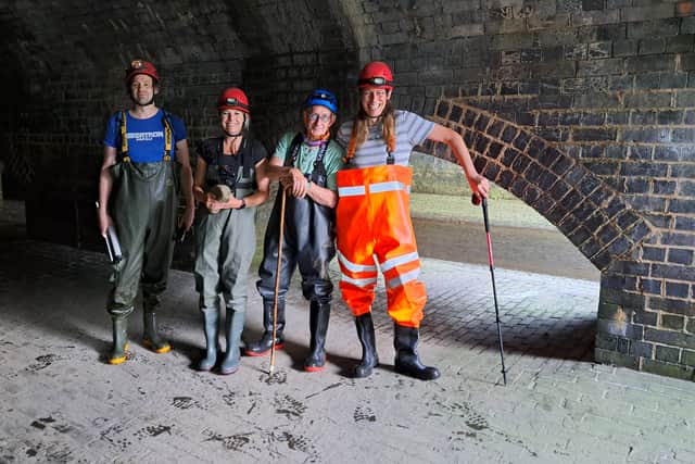 Professor Alice Roberts with Sheaf and Porter River Trust guides Anthony Wood, Simon Ogden and Kevin Leah, in the station culvert at Pond Hill, Sheffield. Alice is holding a piece of a historic grindstone, which she asked to take as a souvenir of Sheffield.