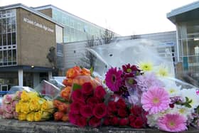 Floral tributes left outside All Saints Catholic High School in Sheffield after Harvey Willgoose was stabbed to death (Richard McCarthy/PA)