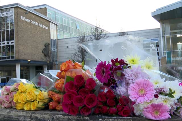 Floral tributes left outside All Saints Catholic High School in Sheffield after Harvey Willgoose was killed (Richard McCarthy/PA)