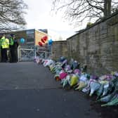Floral tributes were left outside All Saints Catholic High School in Sheffield after Harvey Willgoose was stabbed to death (Jacob King/PA)
