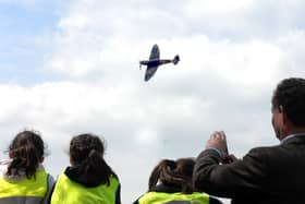 14/5/10  Children from North Duffield Primary School  watch the  Spitfire flypast over the new memorial in  memory of the  men and women of the Armed Forces  who were stationed  on Skipwith Common  and Riccall  RAF Base during World War II ,which was  dedicated at Skipwith Common near Selby yesterday(fri).