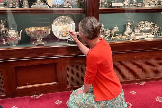 Emma Paragreen, archivist and curator at The Company of Cutlers in Hallamshire explains the details in a silver plate showcasing the classic facade of Cutlers' Hall in Sheffield