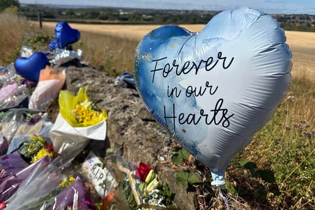 Flowers and tributes left at the scene of a fatal road traffic accident on Denaby Lane.