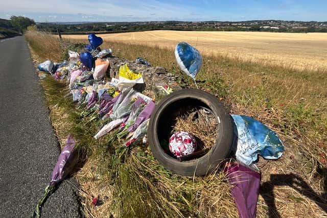 Flowers and tributes left at the scene of a fatal road traffic accident on Denaby Lane.