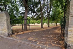 Double gates on a vehicular entrance to Hillsborough Park on Middlewood Road are open after travellers left.