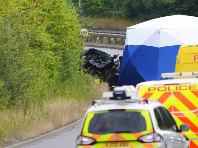 Police officers at the scene of a fatal crash involving a police car and a Volkswagen Passat on the A66 in South Bank, near Middlesbrough. Credit: Owen Humphreys/PA Wire