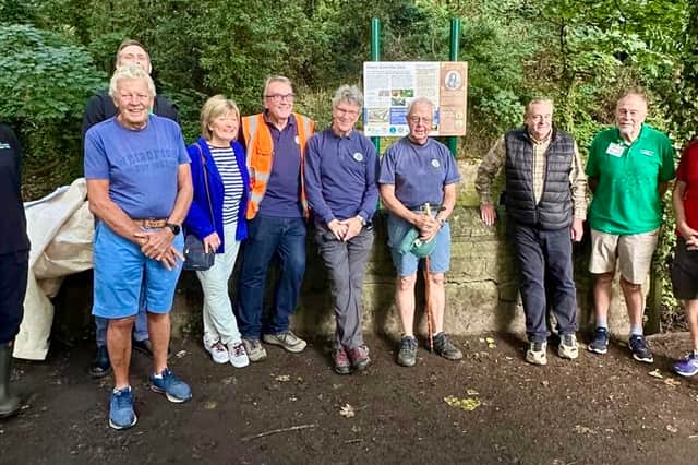 Volunteers at the site of the new sign,