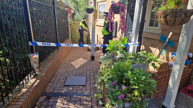 A bouquet of pink and white flowers have been left outside the property on Holywell Heights, Wincobank.