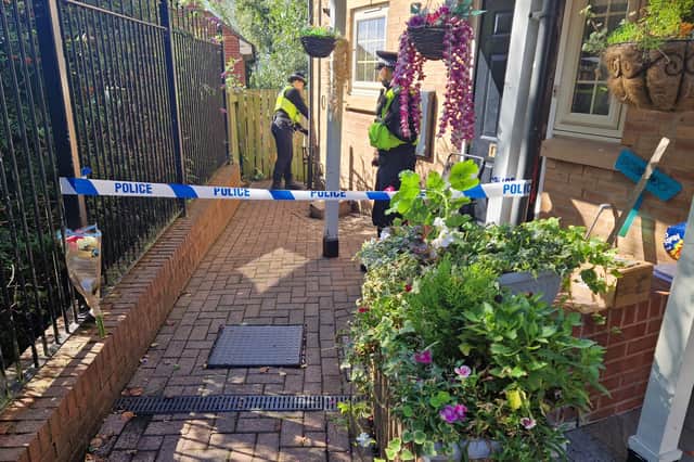 A bouquet of pink and white flowers has been left outside the property on Holywell Heights, Wincobank.