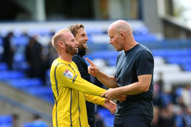 Barry Bannan (left) has a word with boss Henrik Pedersen after the Owls’ 2-1 win at Peterborough United.