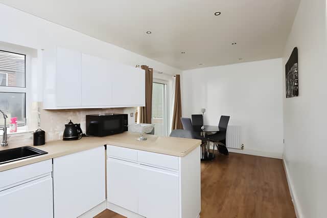 The spacious main kitchen includes ample dining space, creating a practical hub for family meals and entertaining