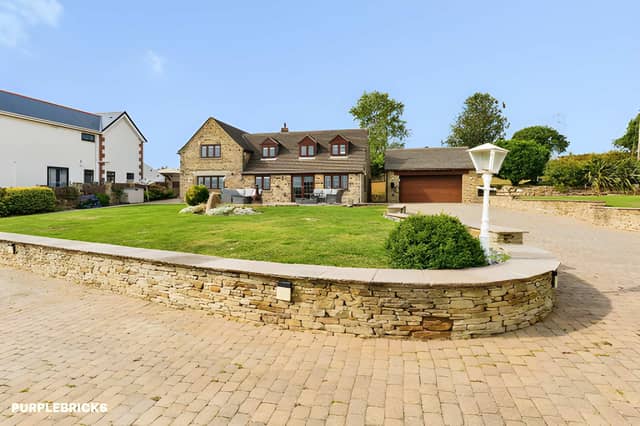 A sweeping driveway leads through the substantial plot towards this characterful stone country home