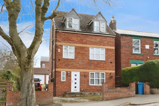 A private driveway leads towards the substantial family home and its double garage