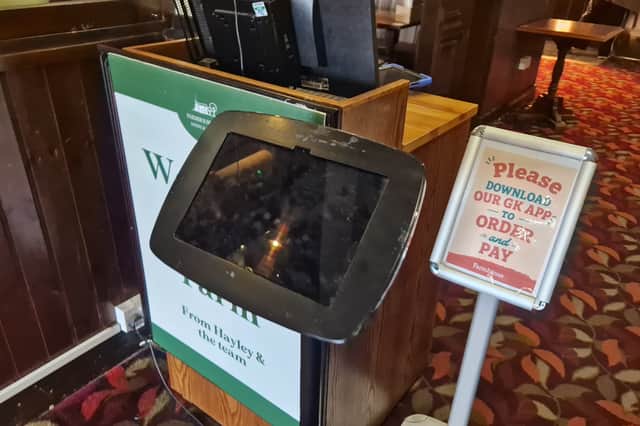 Customers who arrive at the Meadow Farm pub by car must input vehicle details on a tablet at reception.