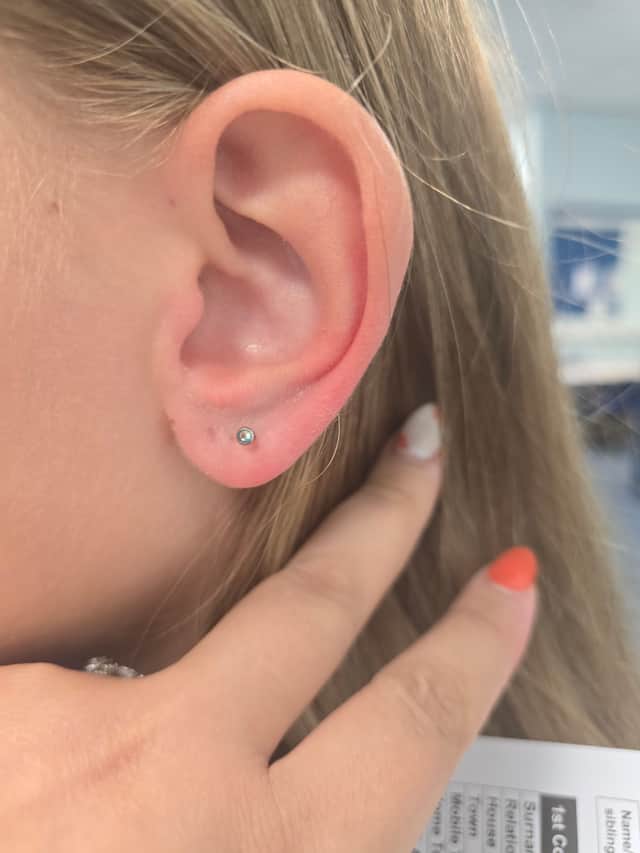 A Y8 girl's ear studs had her facing a week of isolation at Mercia Northridge because of a tiny green gem. Her mum says the policy sent home to parents did not specify that ear studs had to be entirely gold or silver.