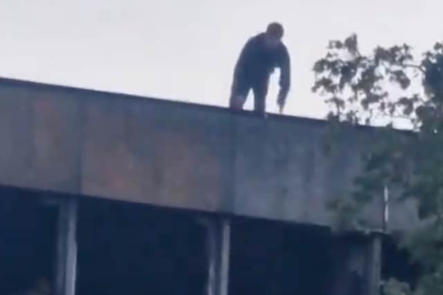 Trespasser about to climb down from roof of Fulwood House.
