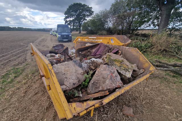 Two skips have been filled with discarded farm items, metal sheeting, pieces of concrete and bushes.