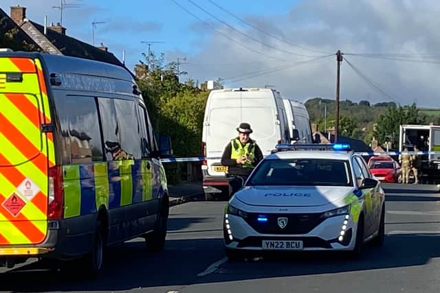 The armby bomb disposal team can be seen in the background inside the evacuation zone in High Green, Sheffield. Photo: Iconic Media