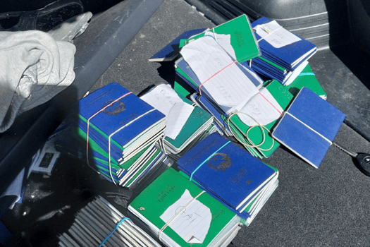 A stack of 220 Vietnamese passports found in Quang Van Nguyen's boot in September 2025, which set investigators on the trail of the gang's sophisticated people smuggling operation.