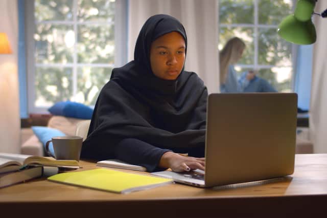 File photo of a young woman wearing an abaya. The conservative Muslim dress covers the head, hair, and obscures the wearer's body.