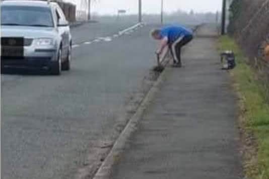 Geoff Evans clearing out the side of a road