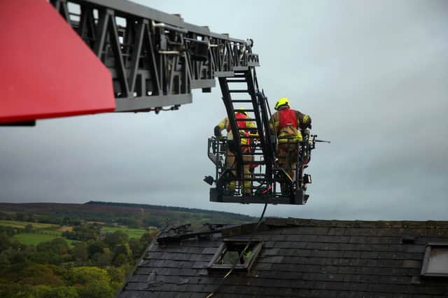 Firefighters on the aerial platform battling a fire on The Grove, Totley, Sheffield. Photo: South Yorkshire Fire and Rescue