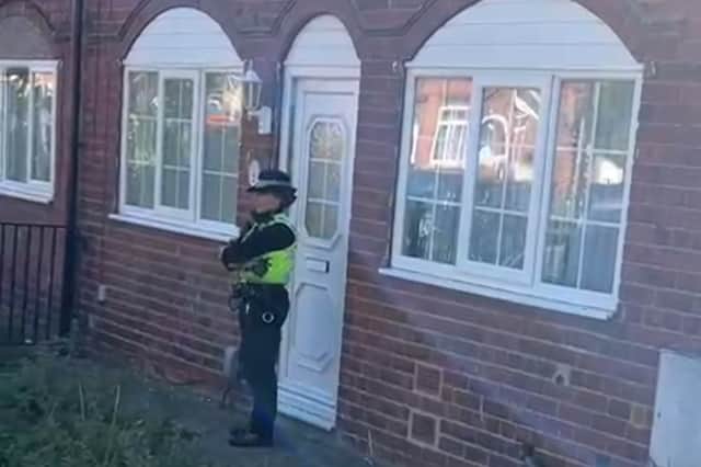 A police officer outside a house on Heather Road, near Firth Park, Sheffield, today. Photo; Dean Atkins, Iconic Media