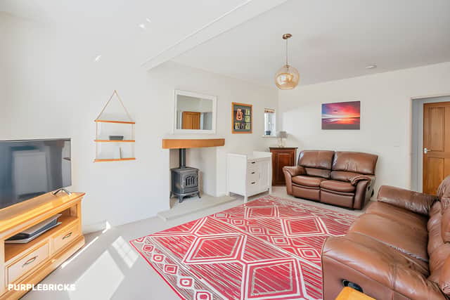 A welcoming living room provides a spacious setting for relaxing and entertaining within the adaptable home