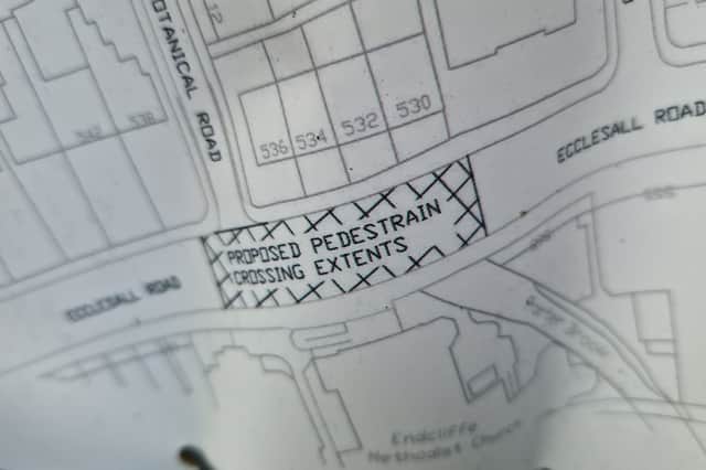 Sign on a lamppost showing location of new pedestrian crossing on Ecclesall Road near the Porter Brook pub.