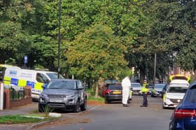 Officers in white overalls at the police incident on Horninglow Road. Photo: Finn Smith, Iconic Media