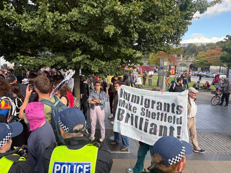 One flag said: "Immigrants make Sheffield brilliant"