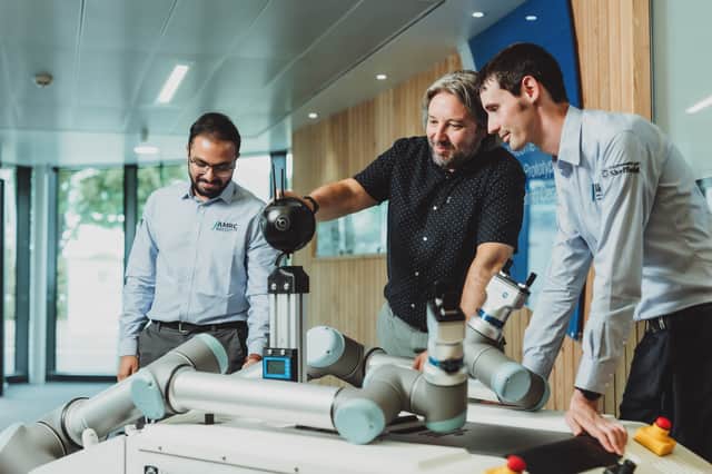 Prof David King works with AMRC engineers on robotic technology developed by his team.